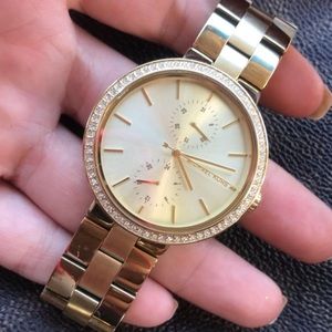 MICHAEL KORS gold watch.